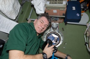 ESA's astronaut Paolo Nespoli, Expedition 26 flight engineer, uses a still camera at a window in the Zvezda Service Module during rendezvous and docking shuttle Discovery, 26 February 2011. Credits: ESA/NASA