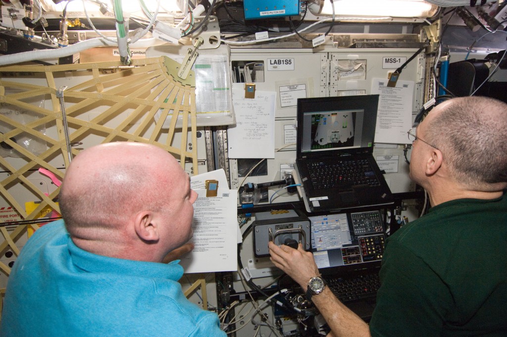 NASA astronaut Don Pettit (right) and European Space Agency astronaut Andre Kuipers, both Expedition 30 flight engineers, conduct the first of three sessions on the ROBoT simulator in preparation for the arrival of the SpaceX Dragon. Credit: ESA/NASA