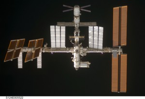 Old picture (June 2008) showing ATV-1 at the top (with the X-shaped solar arrays) and Columbus bottom right (white arrow). Note that the ISS has evolved since then! Credit: NASA