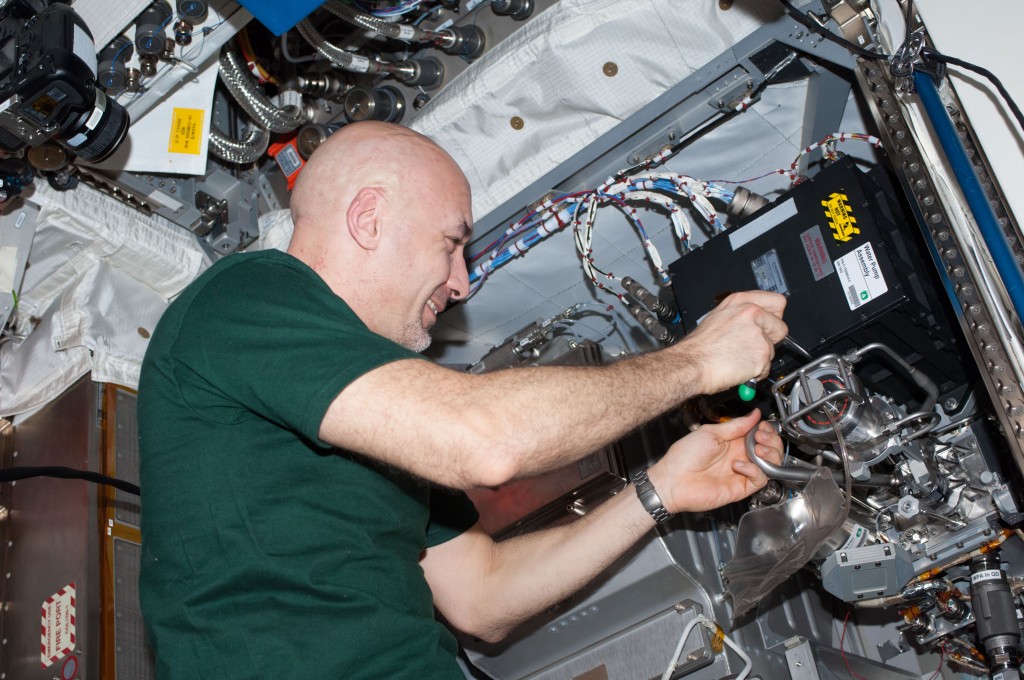 29 July 2013 --- ESA astronaut Luca Parmitano, Expedition 36 flight engineer, performs maintenance on the Water Pump Assembly 2 / Thermal Control System (WPA2/TCS) in the Columbus laboratory of the International Space Station. The pump was delivered to space via ATV-4. Credit: ESA/NASA