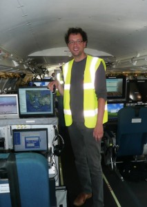 Dirk on aircraft next to monitoring screens