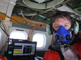 Tom Jordan flying on oxygen, with laptops monitoring the live stream of geophysical data. (BAS)