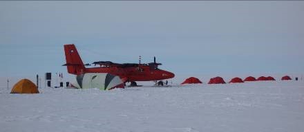The Twin Otter survey aircraft at Thiels camp with the living tent in the background. Sleeping tents were laid out in a line running away from the camp. (Carl Robinson)