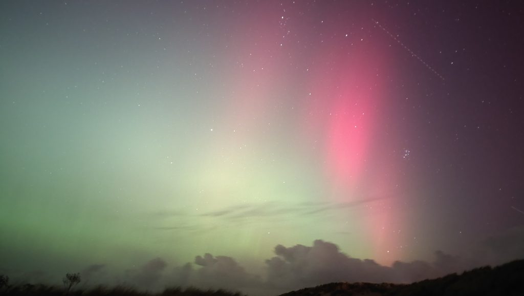 A satellite (not EarthCARE) crosses the northern lights illuminating the night sky during the geomagnetic storm of 10 October 2024. (EJR-Quartz/European Space Agency-Peter Bickerton)