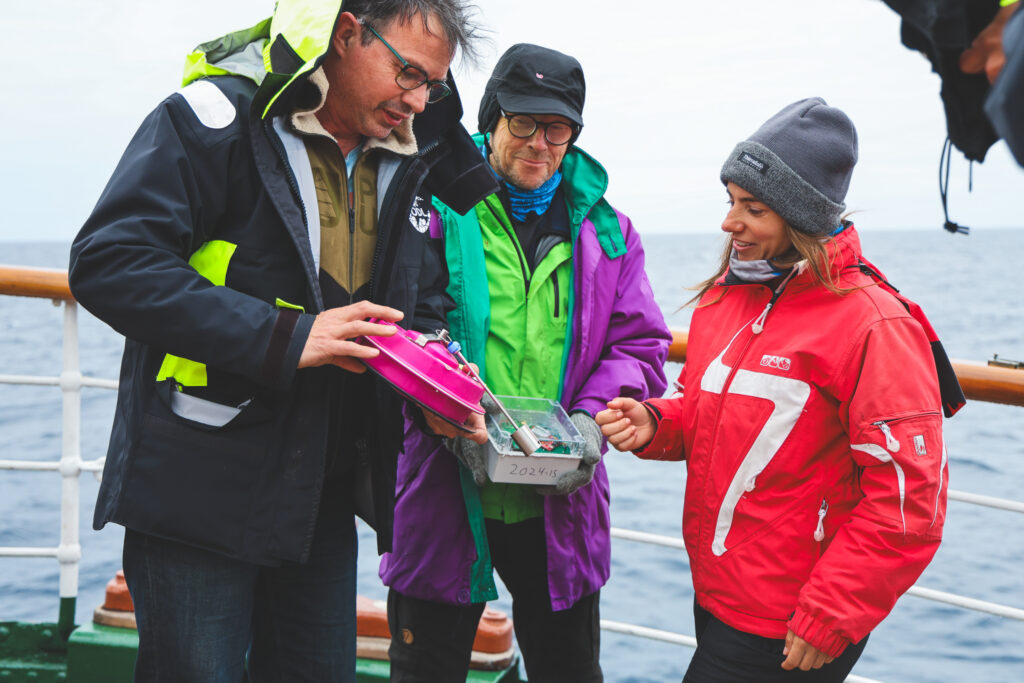 Fabrice Collard & Johnny Johannessen showing student Victoria Christine Zoeller the surface wave drifting buoys, which measure position and wave height as they drift. (Ocean Media Lab)