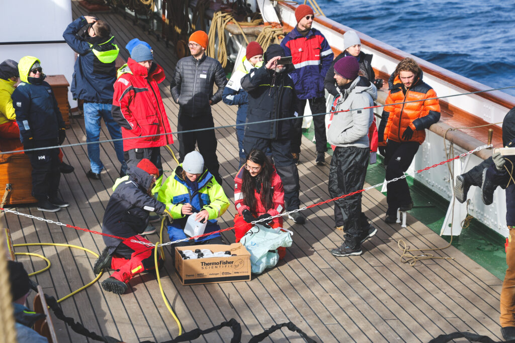 The biology team getting ready to collect water from the conductivity, temperature and depth rosette. (Ocean Media Lab)