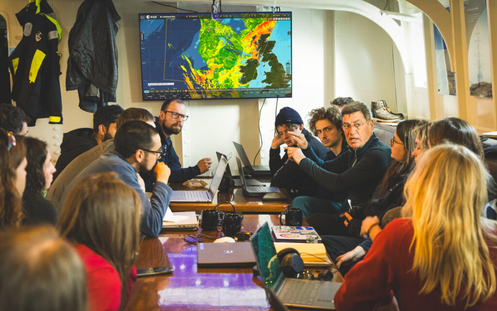 Florian Le Guilou, former ESA research fellow, Artem Moiseev from the Nansen Center, and Roger Haagmans former GOCE and Swarm mission scientist at ESA, mentoring students on station planning. (ESA/Ocean Media Lab)