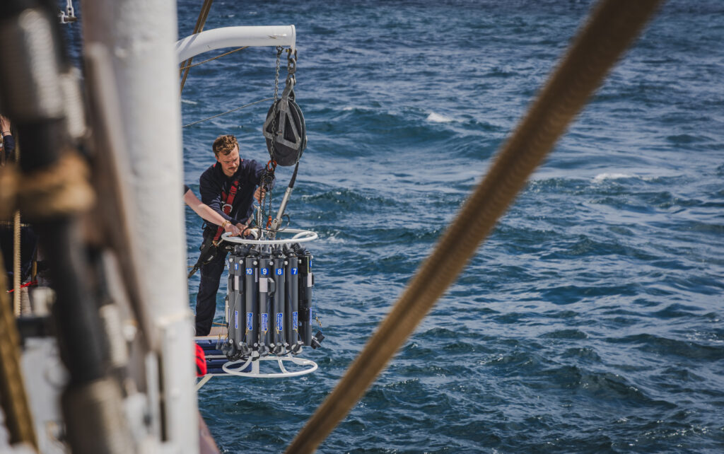 Deck & watch leader monitors the descent of the CTD rosette into the deep. PAP is one of the world’s longest-running deep ocean monitoring stations, and now the Ocean Training Course students are part of its data legacy. (Ocean Media Lab)
