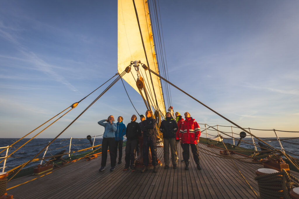 At the golden hour, students, crew and citizen scientists gather at the bow – eyes fixed aloft, learning not just the mechanics of sailing, but the mindset of observing the ocean from space. (Ocean Media Lab)