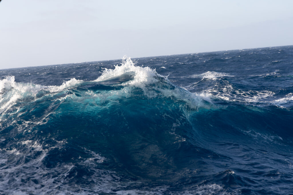 Wave crests off the Portuguese shelf, revealing the deep blue force that satellites trace from above. This is the frontier where remote sensing meets the real sensation – the ship feels every roll. (Ocean Media Lab)