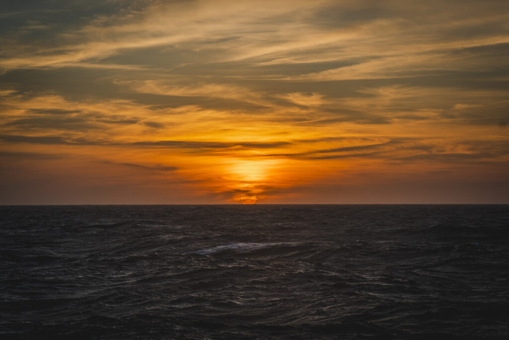 The sun sinks into the Atlantic – an everyday event, but one loaded with meaning out here. Every sunset reminds us of the rhythms we're here to study, and protect. (Ocean Media Lab)