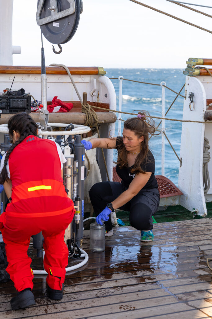Lecturer Sejal Pramlall, PhD candidate at the University of Bergen, and student Lou Àndres collecting water. (Ocean Media Lab)