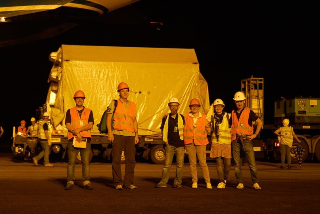 Team in front of satellite container. (ESA)
