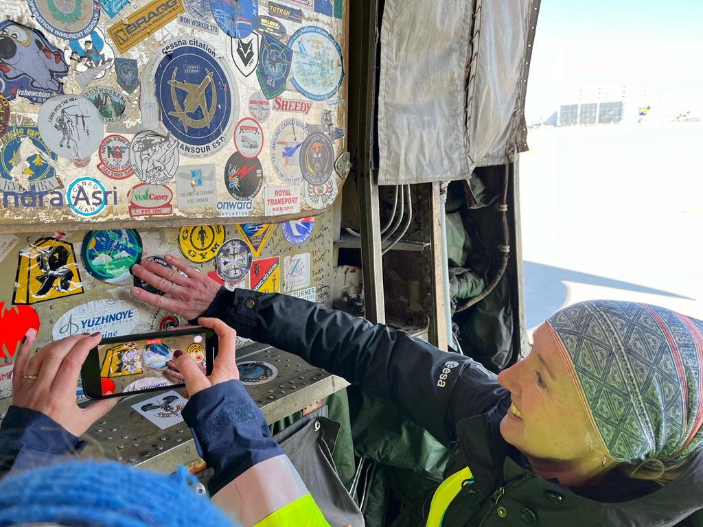 Sticking the EarthCARE mission patch onto the aircraft. (credits: ESA)