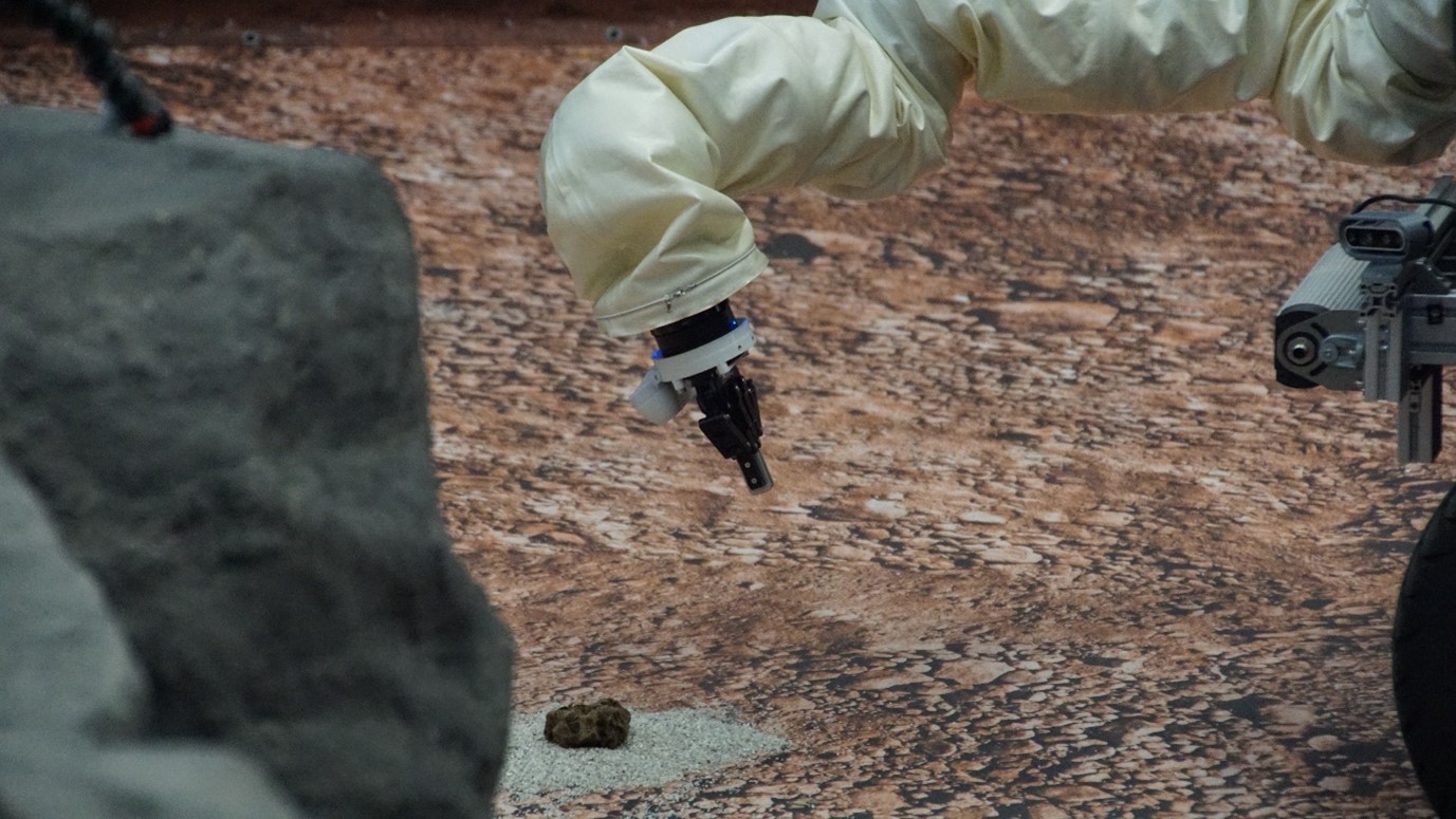 ESA's Interact rover and its robotic arm picking up samples at Oberpfaffenhofen. Credit: ESA/DLR