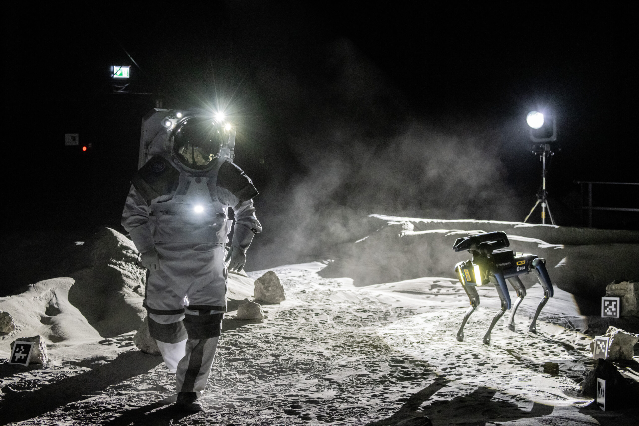 An astronaut accompanied by Spot at the LUNA inauguration show. Credit: ESA/DLR