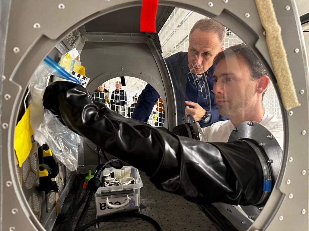 ESA project astronaut Sławosz Uznański working with the glovebox during a parabolic flight campaign. Credits: ESA/Novespace