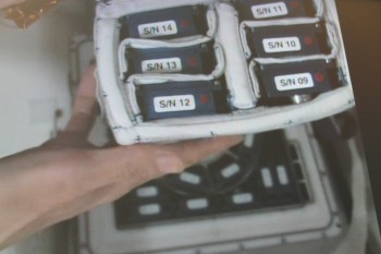 Japanese astronaut Kimiya Yui showing Endothelial Cells cassettes to camera in space. Credits: Col-CC cam