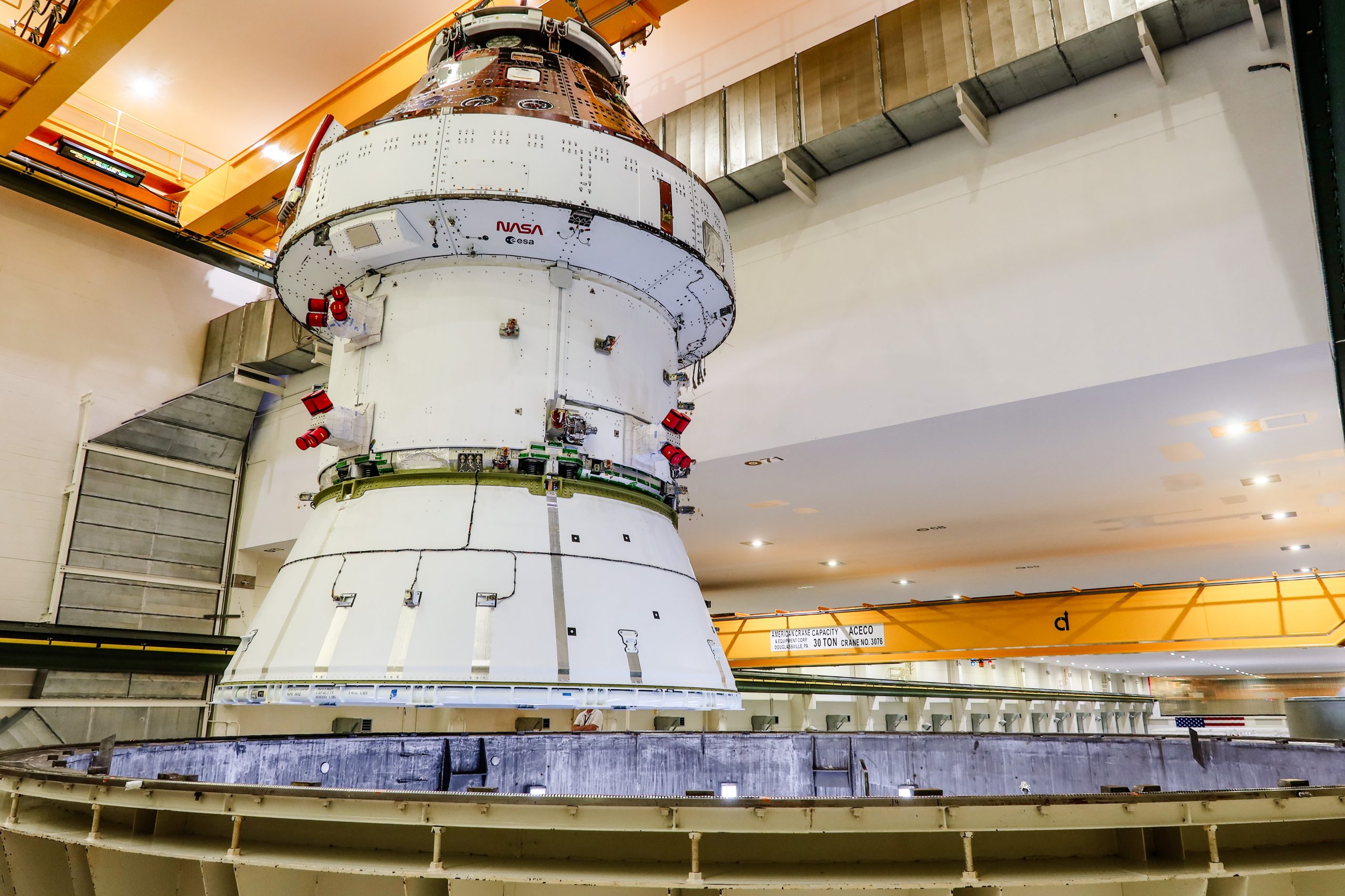 After completing electromagnetic compatibility and interference testing, the Artemis II Orion spacecraft is lifted out of the west altitude chamber via crane inside the Neil A. Armstrong Operations and Checkout Building at NASA’s Kennedy Space Center in Florida on Saturday, April 27, 2024. Credit: NASA-A. Stevenson