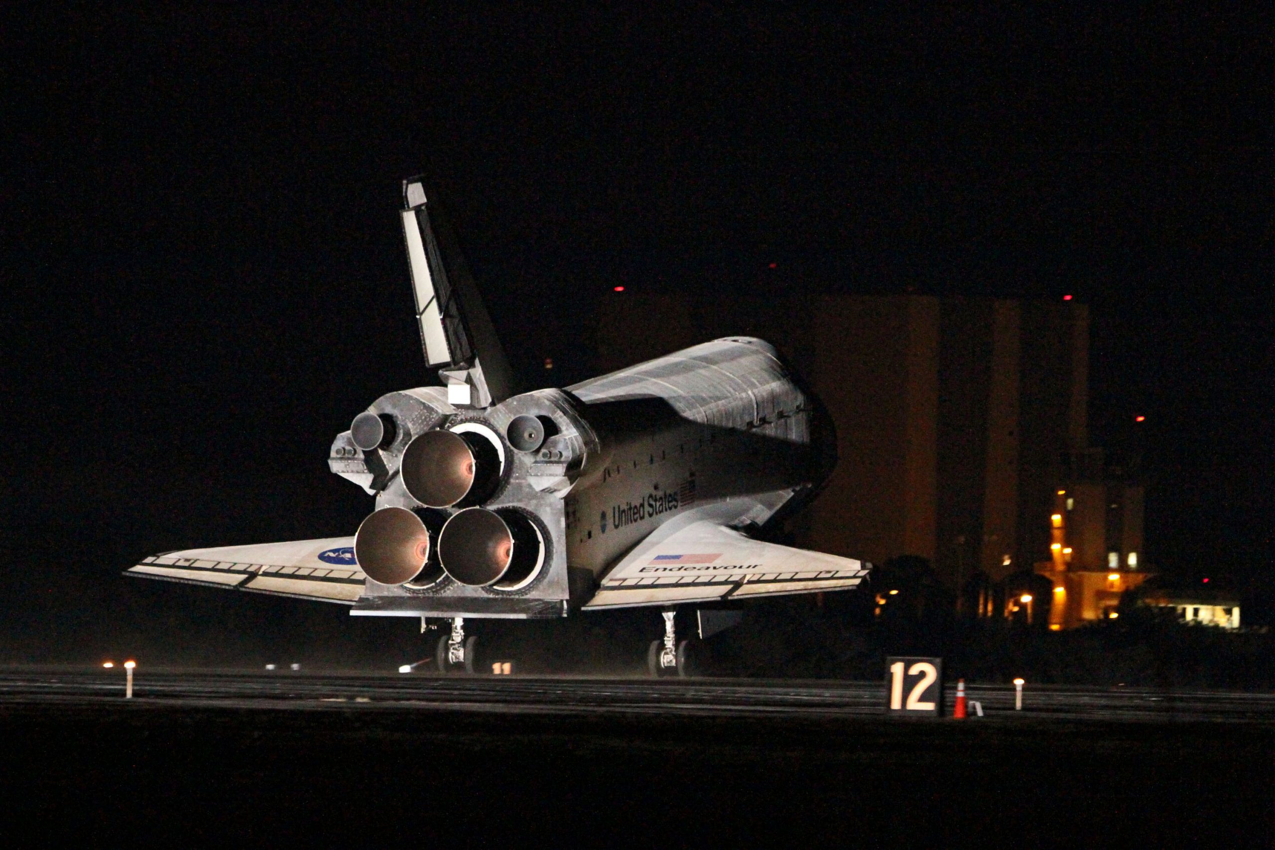 Space Shuttle engines lighting up during the STS-130 mission in 2010. The OMS engines are the two smaller ones above the larger engines. Credit: NASA