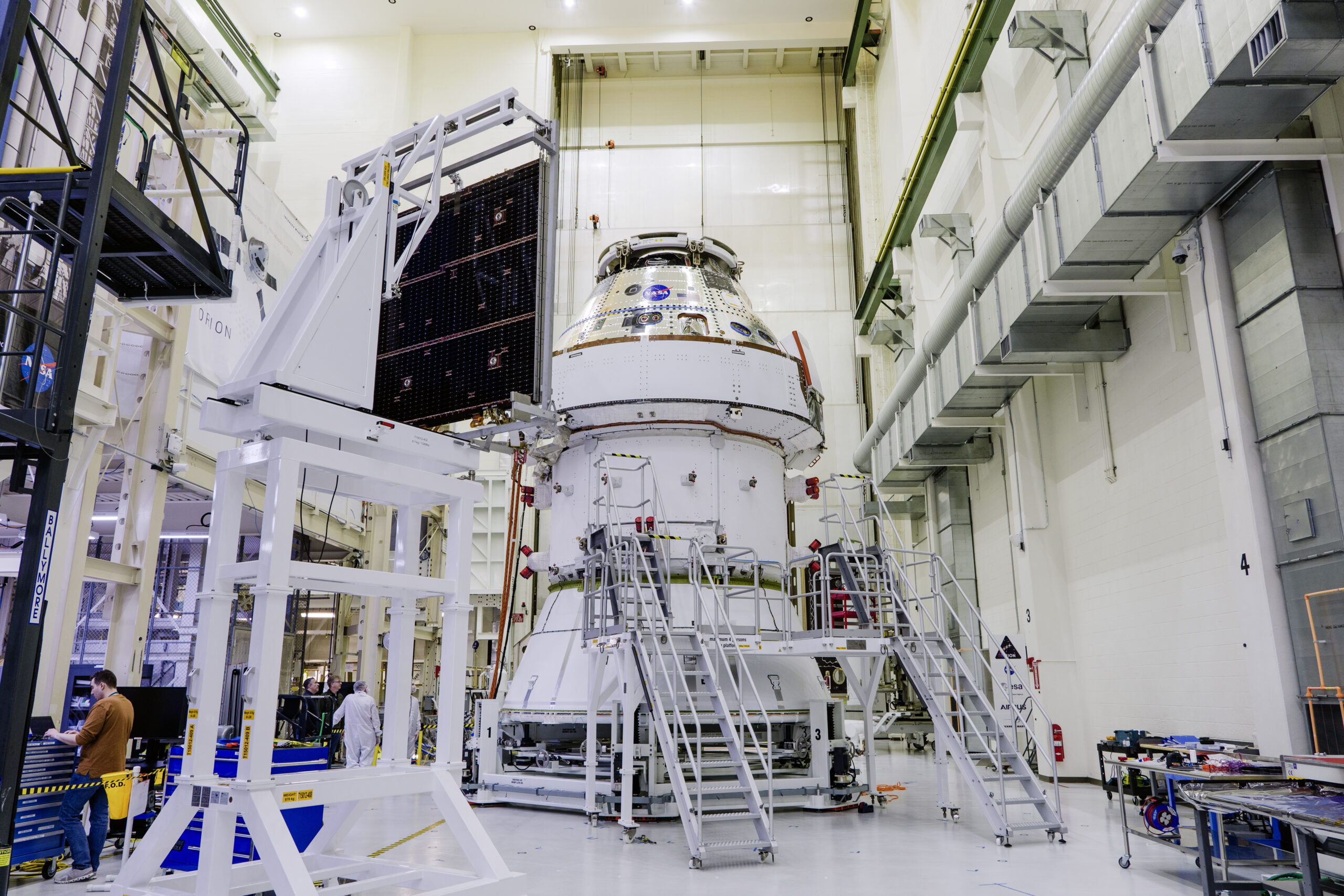 Technicians begin working on the installation of the four solar array wings for NASA’s Artemis II Orion spacecraft inside the Operations and Checkout Building at NASA’s Kennedy Space Center on Feb. 27, 2025. Credit: NASA