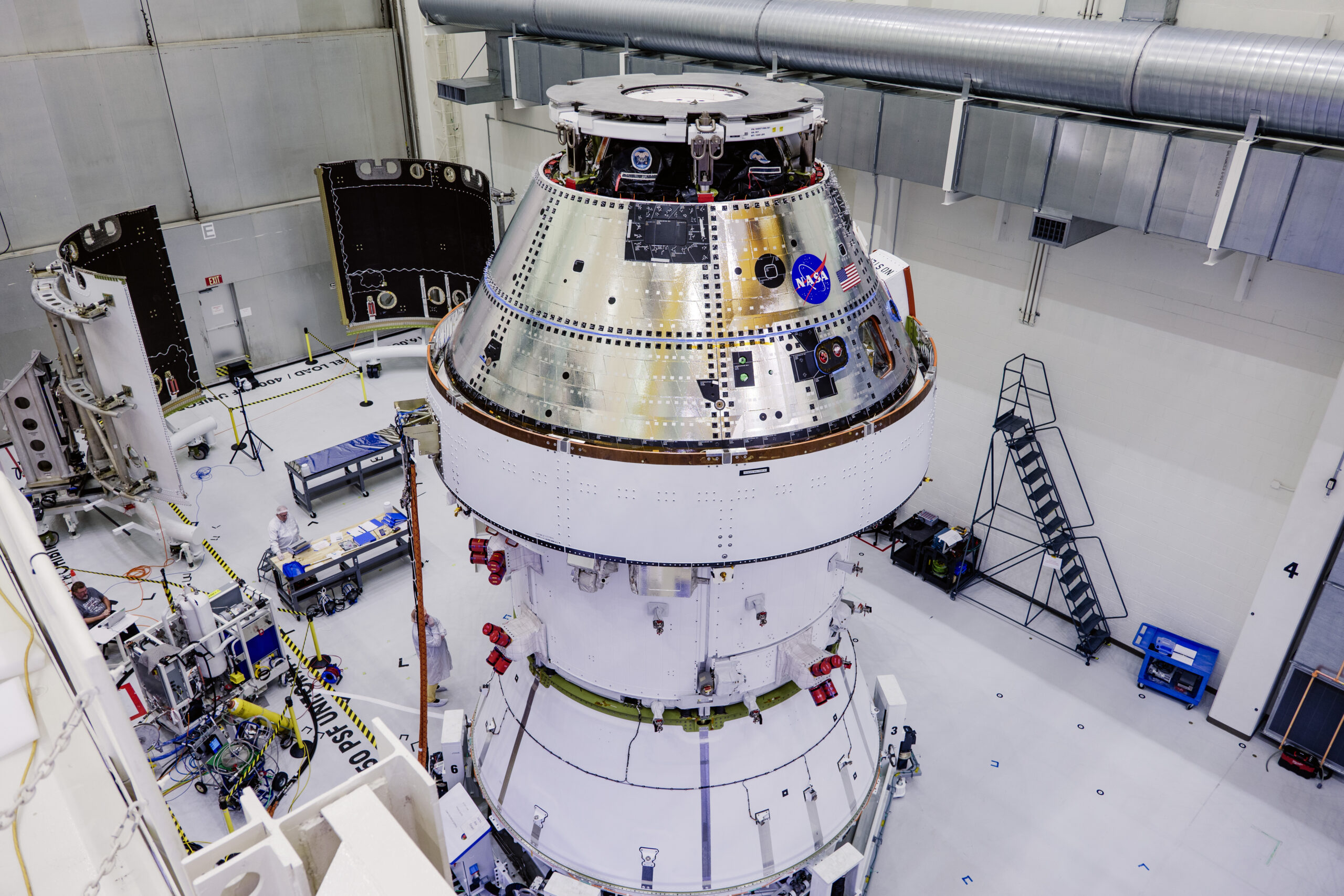 Technicians begin working on the installation of the four solar array wings for NASA’s Artemis II Orion spacecraft inside the Operations and Checkout Building at NASA’s Kennedy Space Center on Feb. 27, 2025. Credit: NASA