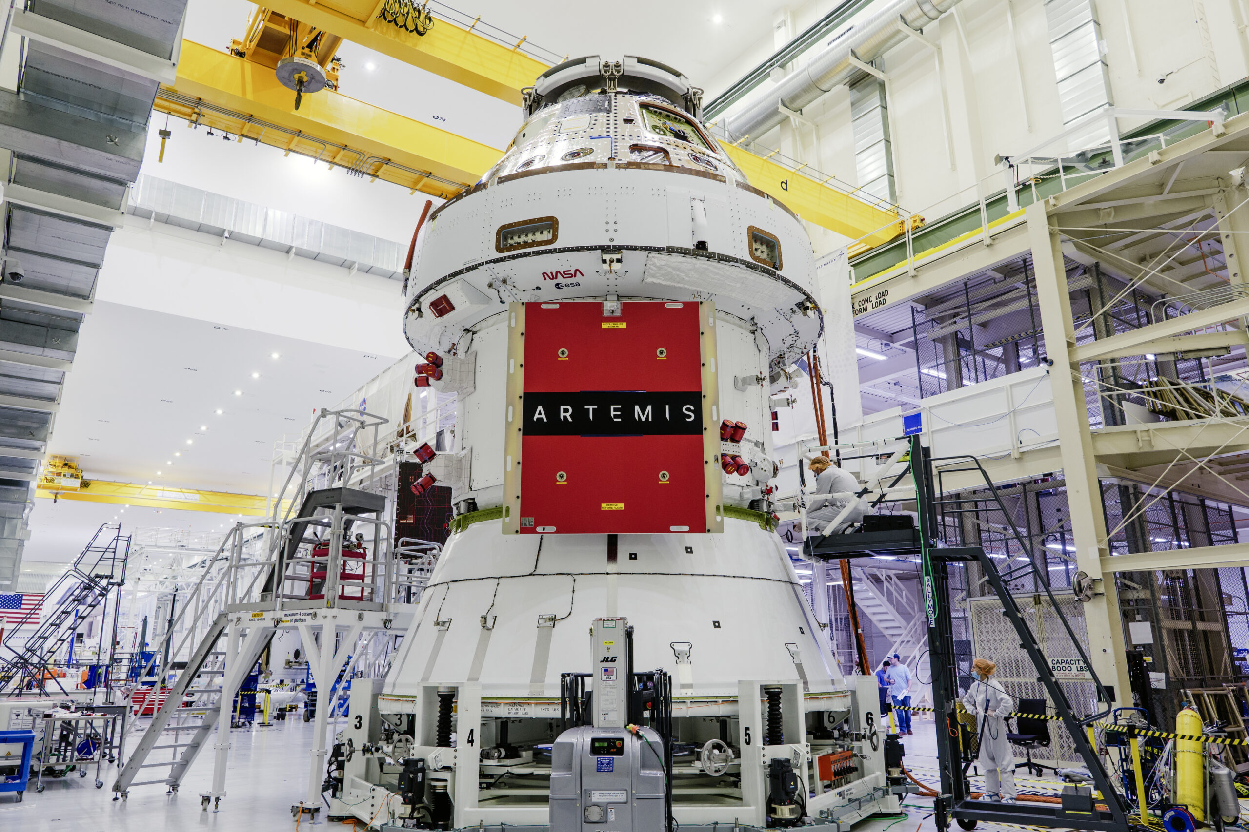 Technicians begin working on the installation of the four solar array wings for NASA’s Artemis II Orion spacecraft inside the Operations and Checkout Building at NASA’s Kennedy Space Center on Feb. 27, 2025. Credit: NASA