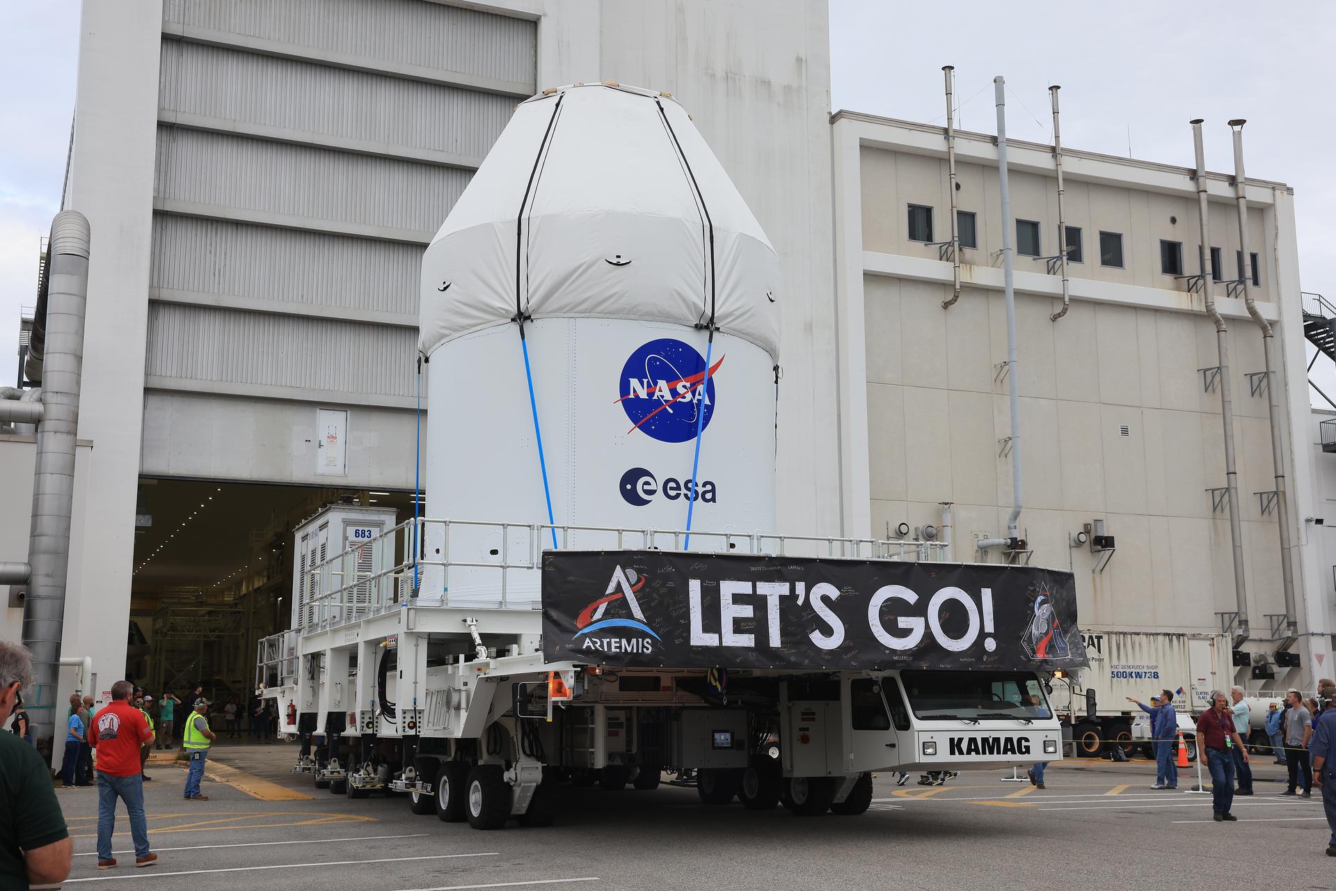 On 3 May, the fully assembled Orion spacecraft for Artemis II began its journey to the Multi-Payload Processing Facility at NASA’s Kennedy Space Center. The spacecraft is shown in transport, with its protective fairing panels clearly visible and proudly bearing the ESA and NASA logos. Credit: NASA-K. Shiflett