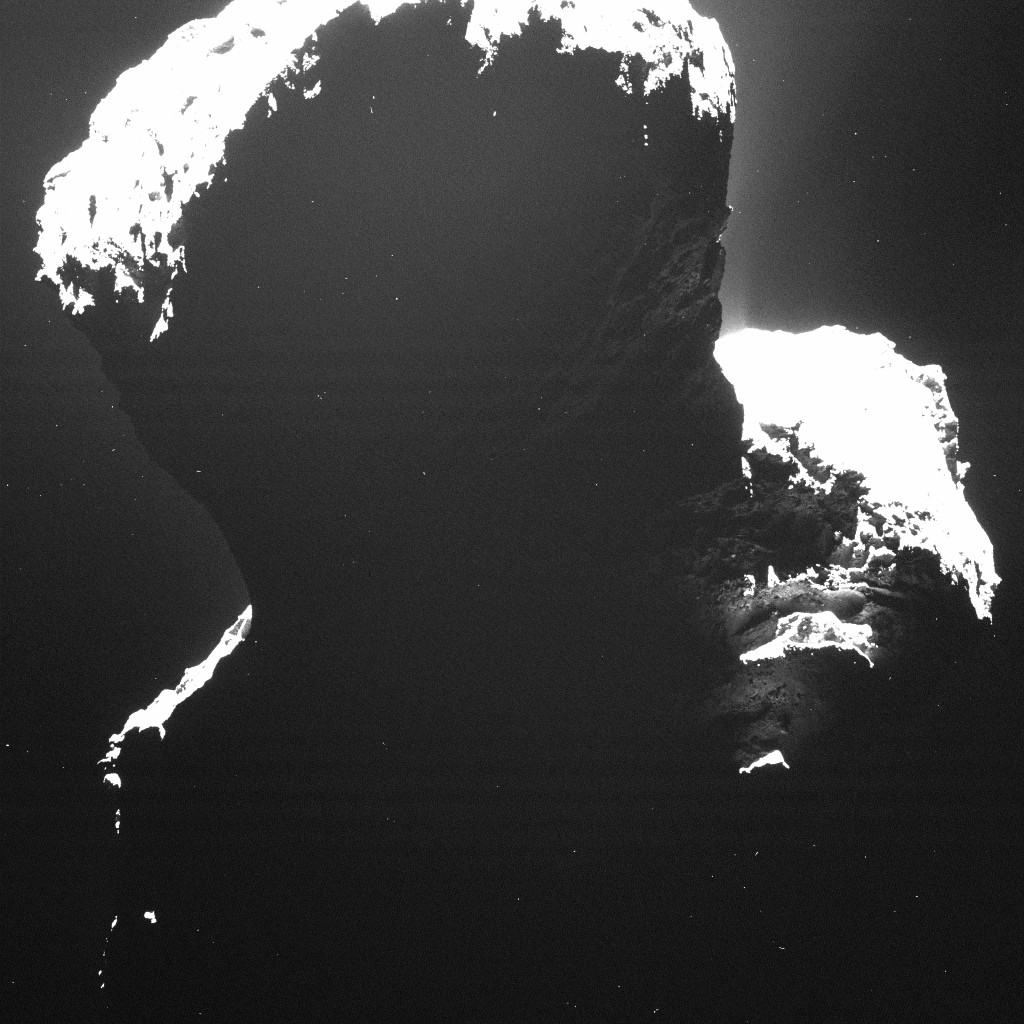 A rare glimpse at the dark side of Comet 67P/Churyumov-Gerasimenko. Light backscattered from dust particles in the comet’s coma reveals a hint of surface structures. This image was taken by OSIRIS, Rosetta’s scientific imaging system, on 29 September 2014 from a distance of approximately 19 kilometres.   ESA/Rosetta/MPS for OSIRIS Team MPS/UPD/LAM/IAA/SSO/INTA/UPM/DASP/IDA  