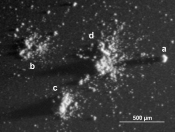Diversity of particles seen on a small area on one single target. This image section measures 2.5 mm across, with light coming from the right. Examples of a compact particle (a), a shattered cluster (b), a glued cluster (c) and a large rubble pile (d) are seen in this small area. Credit: : ESA/Rosetta/MPS for COSIMA Team MPS/CSNSM/UNIBW/TUORLA/IWF/IAS/ESA/BUW/MPE/LPC2E/LCM/FMI/UTU/LISA/UOFC/vH&S/ Langevin et al (2016)