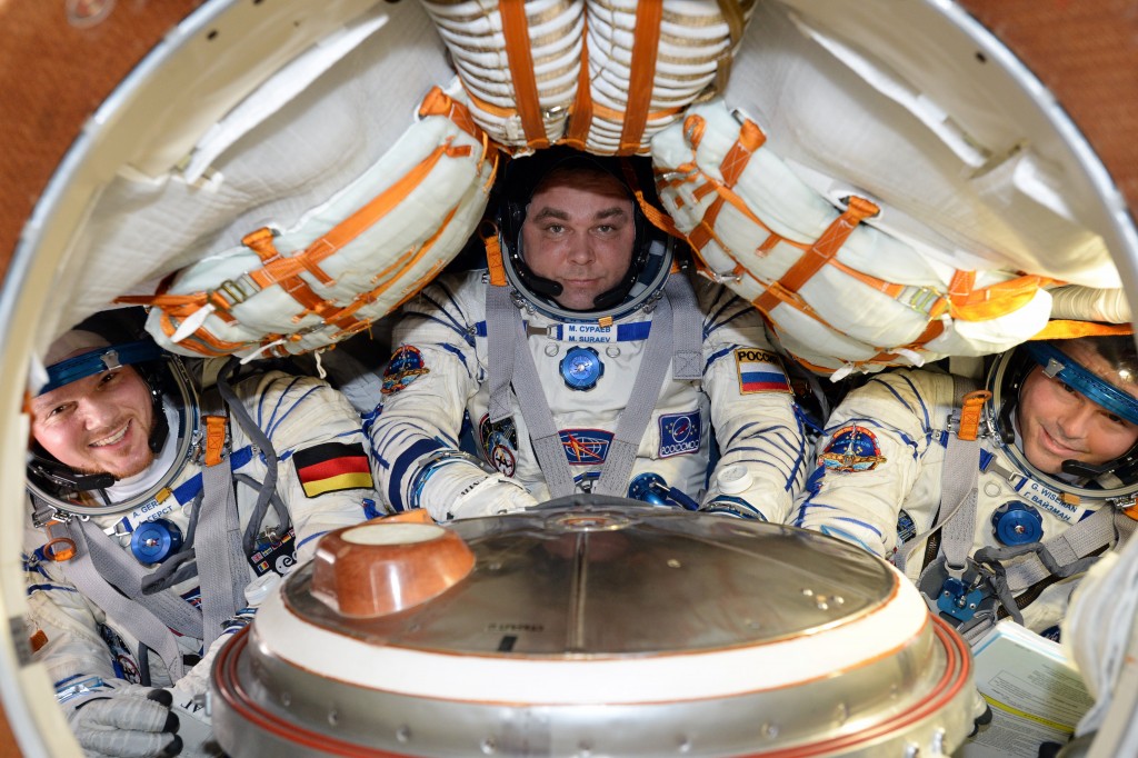 ESA astronaut Alexander Gerst, commander Max Suarev and NASA astronaut Reid Wiseman demonstrat the Soyuz tight fit before their return flight to Earth in 2014. Credits: ESA/NASA