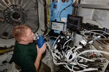 Conducting the Airway Monitoring experiment in the Quest airlock. Credits: ESA/NASA