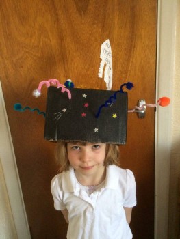 My daughter Eva had to make a hat for a school project. She choose to do the solar system and a rocket with a drawing of Tim in it, and wanted to show him!